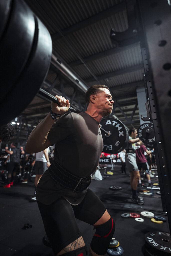 ATHX athlete performing a heavy back squat during competition at ATHX Milan