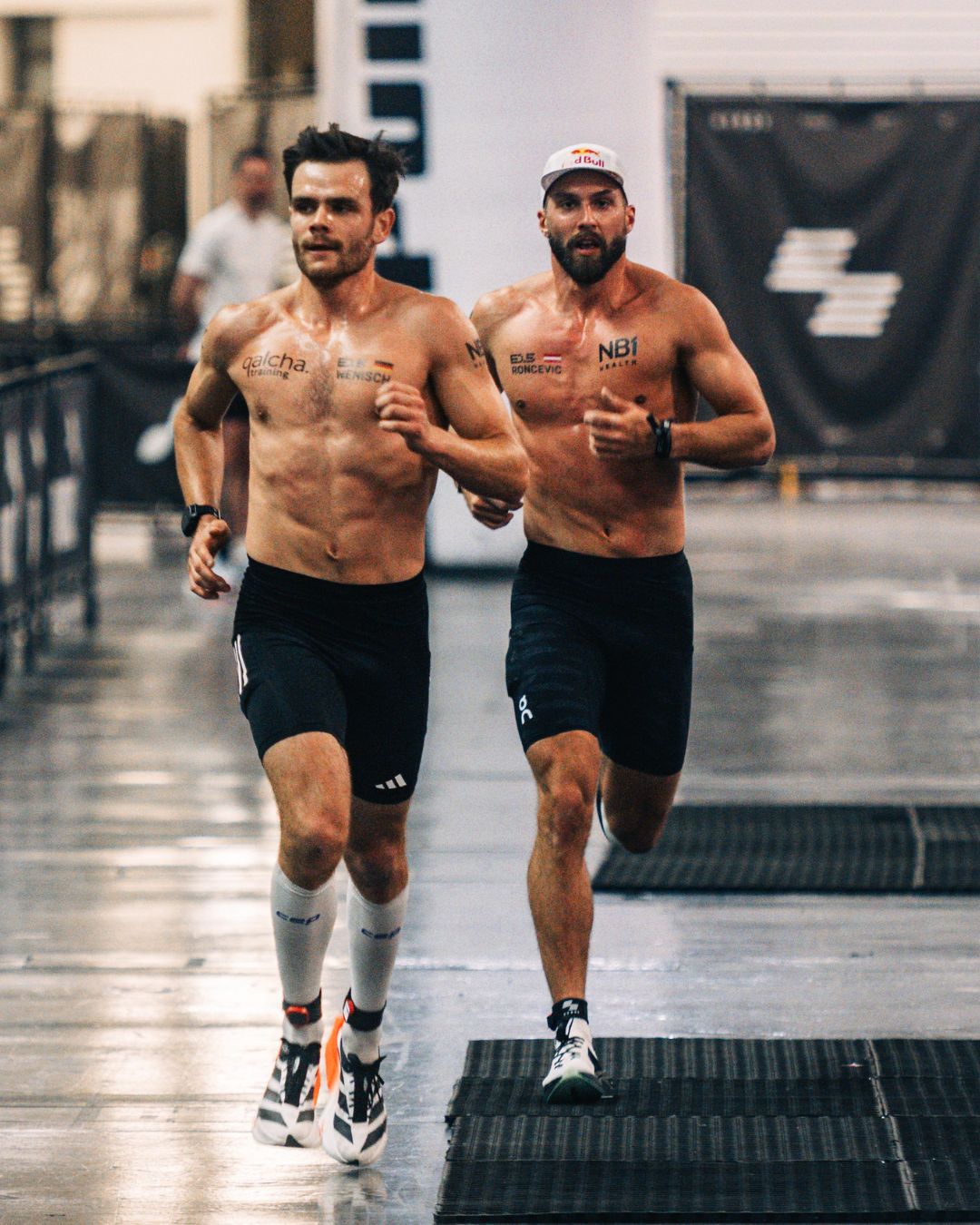 Alex Roncevic and Tim Wenisch running side by side on the HYROX race course during competition
