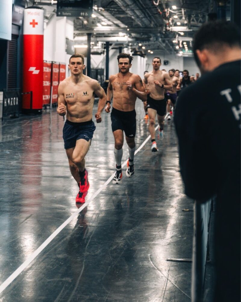 HYROX Elite 15 men running on the race course during competition