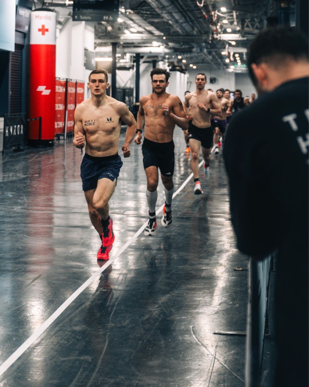 HYROX Elite 15 men running on the race course during competition