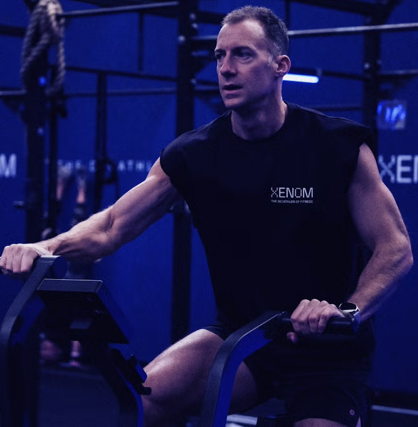 XENOM promotional image showing an athlete on an Echo Bike during training ahead of the company’s first competition in Dallas.