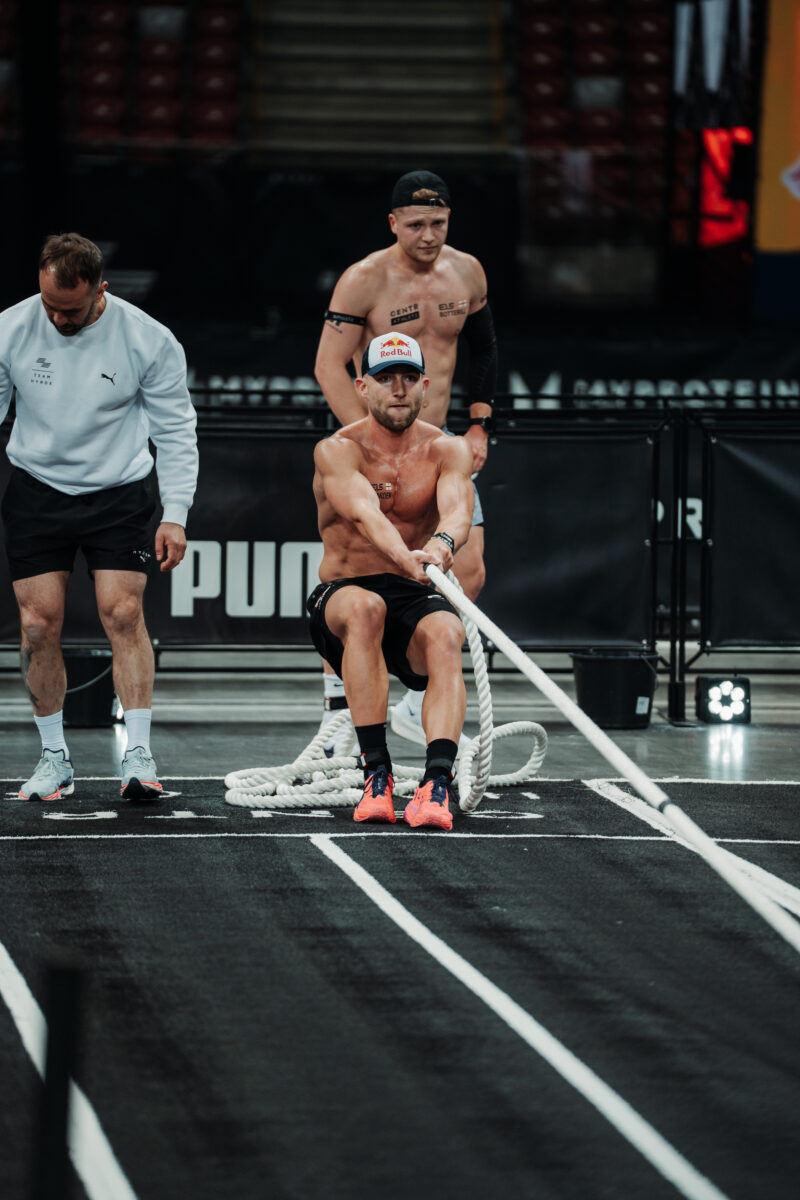 HYROX Elite athlete pulling a rope during Men's Doubles competition at an Elite 15 event.