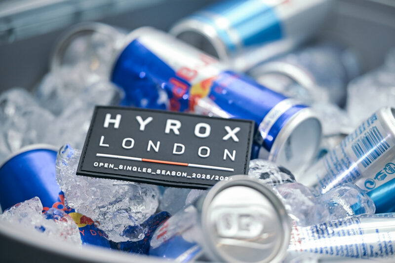 HYROX London event patch on ice with Red Bull cans, representing the HYROX UK Spring 2027 schedule.